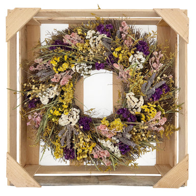Bright wildflower wreath with yellow, purple, pink, white, and green.