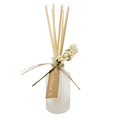 Frosted ridge diffuser with ivory flower tied to bottle and reeds.