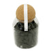 Black incense cones in glass jar with cork lid.