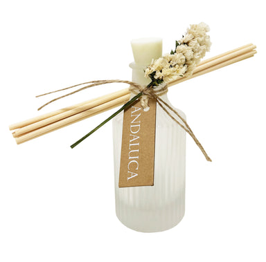 Frosted ridge diffuser with ivory flower tied to bottle and reeds.
