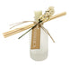 Frosted ridge diffuser with ivory flower tied to bottle and reeds.