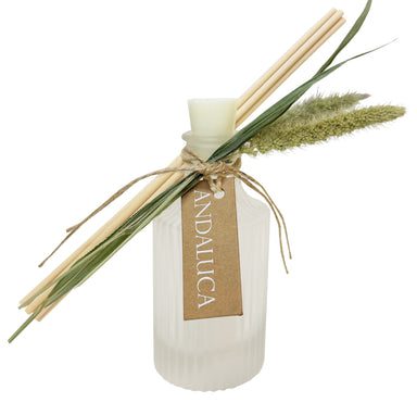 Frosted ridged diffuser glass with botanical element tied to bottle neck and reeds.