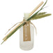Frosted ridged diffuser glass with botanical element tied to bottle neck and reeds.
