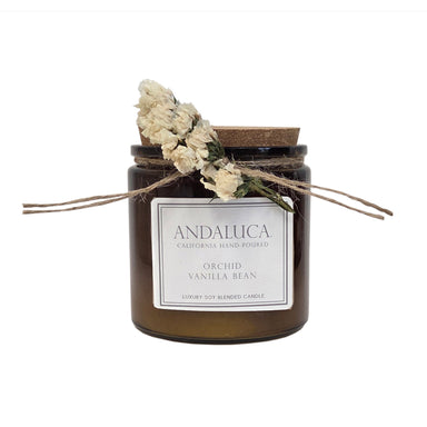 Brown glass candle with ivory flower tied on.