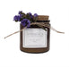Brown glass candle with purple flower tied on.