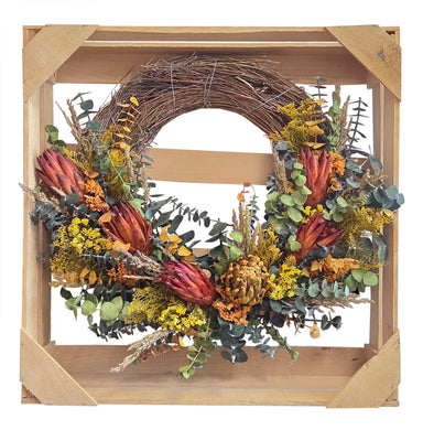 Floral artichoke half wreath in wood crate