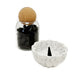 Black incense cones in glass jar and cork lid.