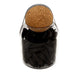 Black incense cones in glass jar with cork lid.