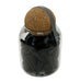 Black incense cones in glass jar with cork lid.