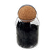 Black incense cones in glass jar with cork lid.