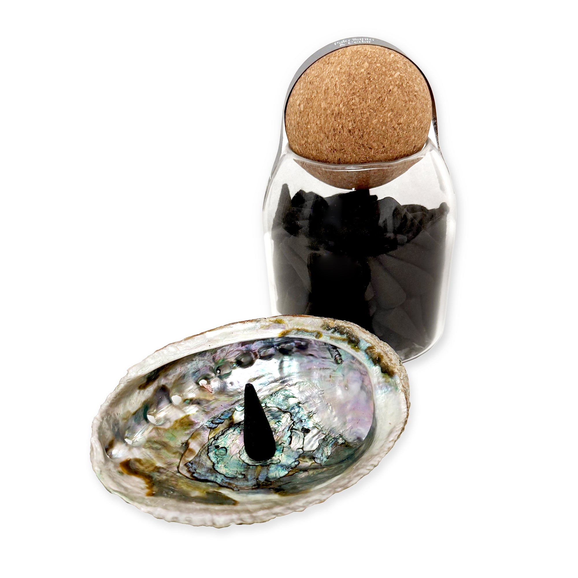 Black incense cones in glass jar with cork lid.