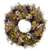 Bright wildflower wreath with yellow, purple, pink, white, and green.