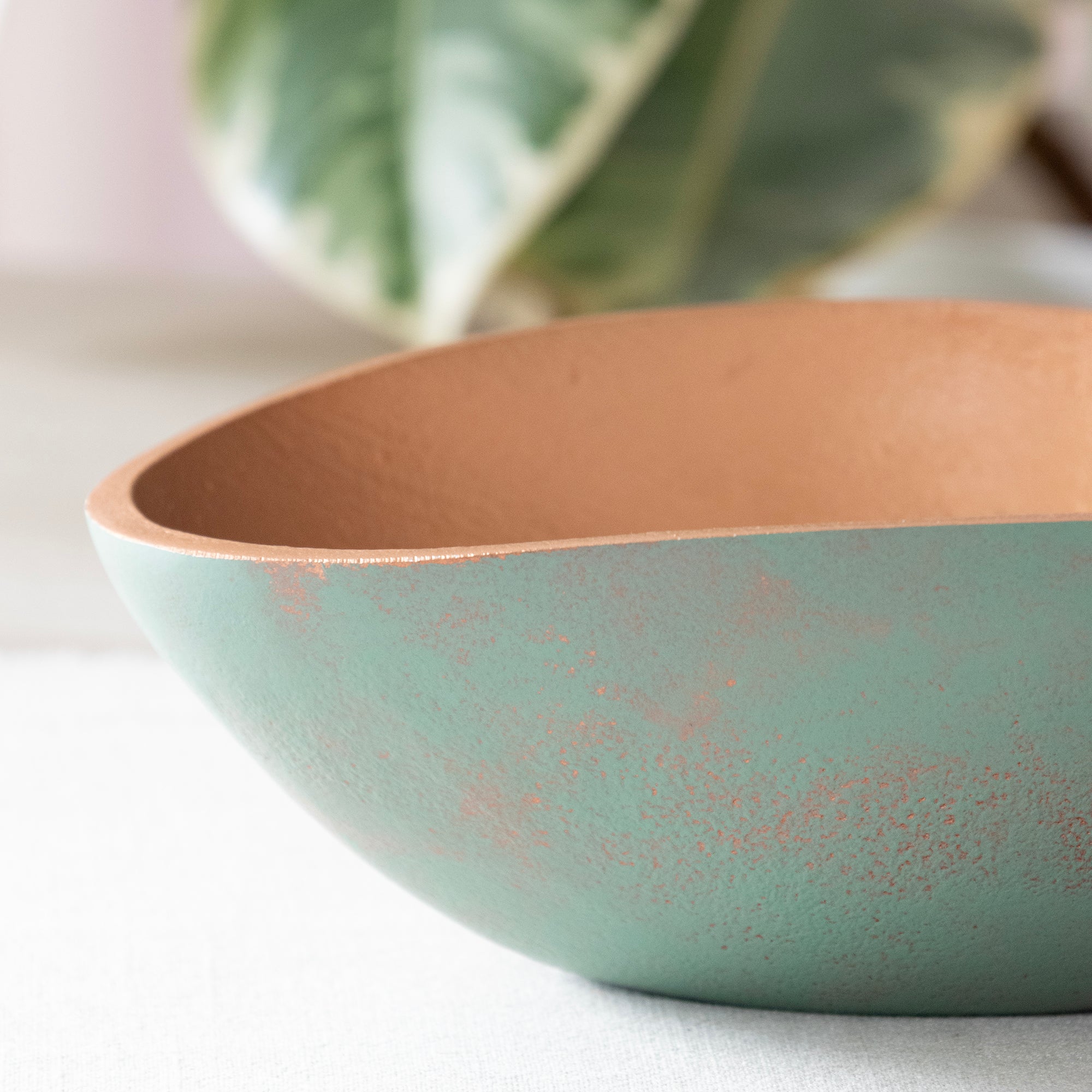 Close up of  one of the,  Set of 3 Turquoise Copper Cast Metal Decorative Bowls, empty bowls in room setting.