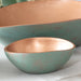 Small bowl of the Set of 3 Turquoise Copper Cast Metal Decorative Bowls, empty bowls in room setting, empty.