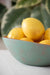 Close up of the small bowl , in the Set of 3 Turquoise Copper Cast Metal Decorative Bowls, empty bowls in room setting, filled with lemons.