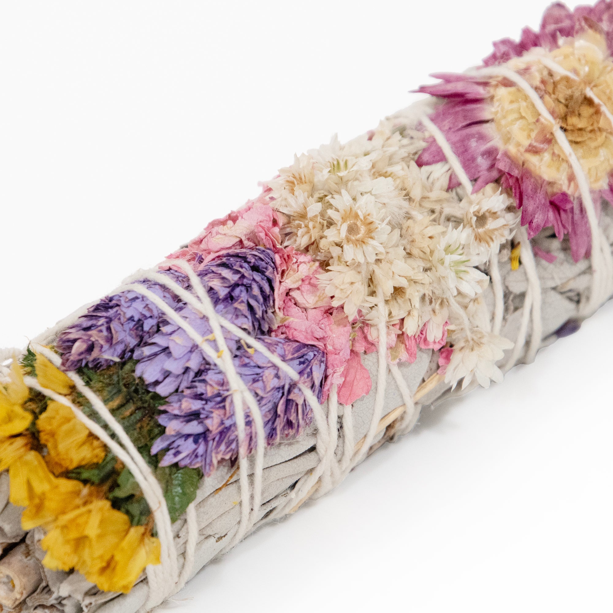 Colorful floral white sage smudge stick.