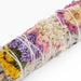 Colorful floral white sage smudge stick.
