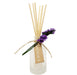 Frosted ridge glass diffuser with reeds and a purple flower tied to the bottle.