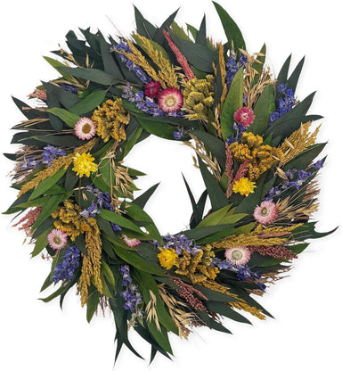 Wreath made of green leaves and colorful flowers on a white background