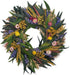Wreath made of green leaves and colorful flowers on a white background