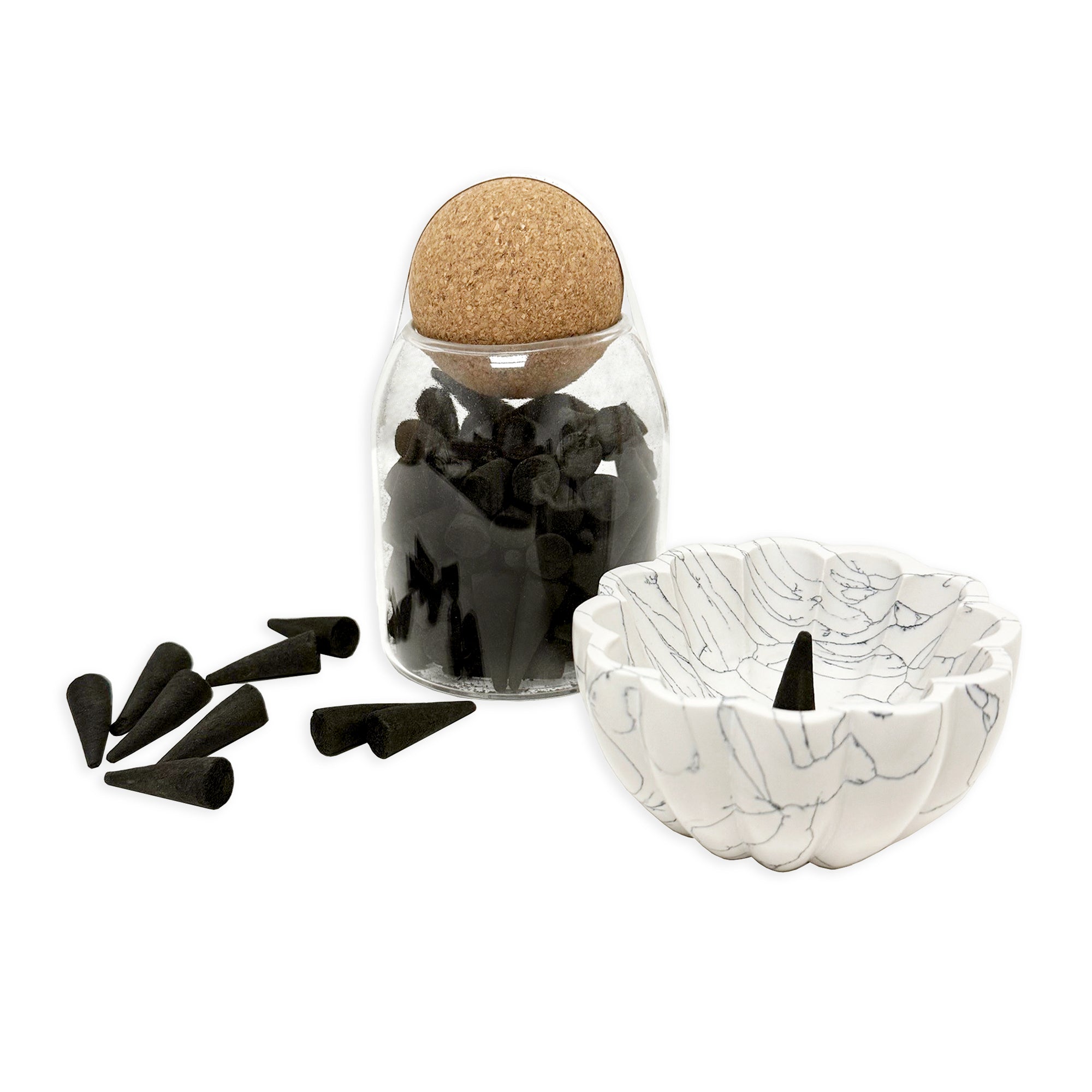 Black incense cones in glass jar with cork lid.