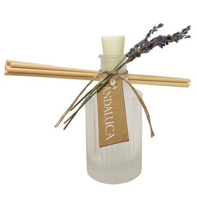 Frosted ridge glass diffuser with reeds and a lavender sprig tied to the bottle.