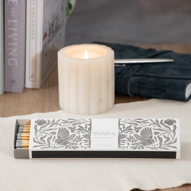 Grey and white box of matches in floral pattern.