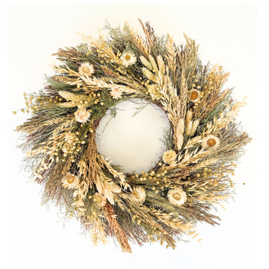 A circular dried floral wreath made of natural beige, tan, and olive green botanicals, including grasses, small flowers, and seed pods, photographed against a plain white background.
