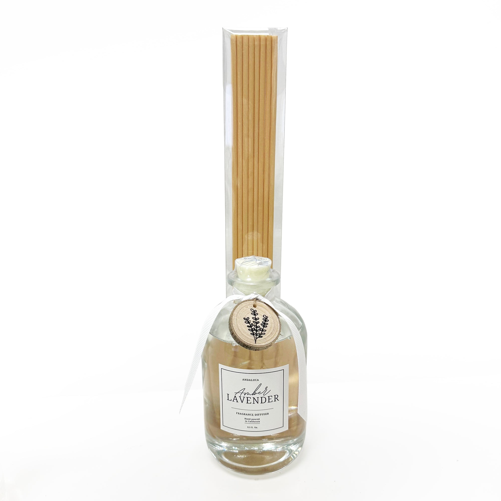 Bottle of lavender-scented reed diffuser with wooden sticks on a white background