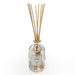 Reed diffuser with wooden sticks in a clear bottle on a white background
