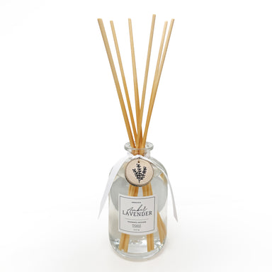 Reed diffuser with wooden sticks and a clear bottle labeled 'Lavender' on a white background