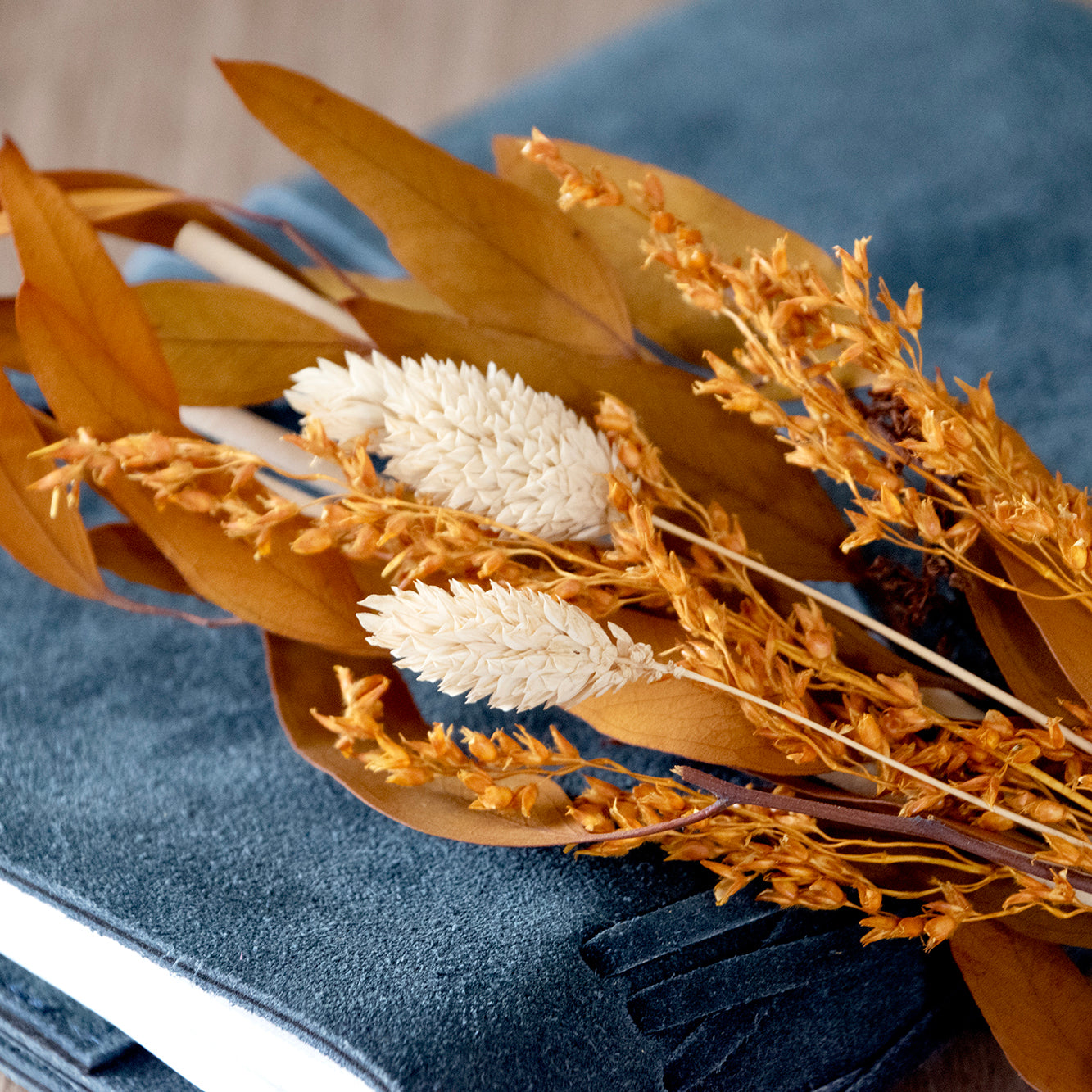 Close up of diffuser reeds and bouquet of dried flowers.