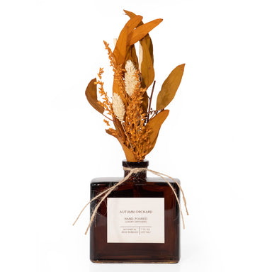Autumn Orchard hand-filled diffuser, on a white background.  Diffuser reeds are arranged in an autumn bouquet of dried flowers.