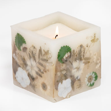 Pressed white flower hurricane candle filled with  wax.