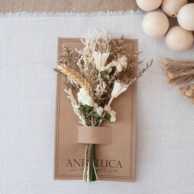 Mini dried floral bouquet in ivory and natural botanicals on kraft backer card.