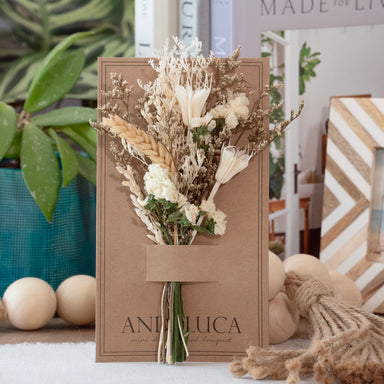 Mini dried floral bouquet in ivory and natural botanicals on kraft backer card.