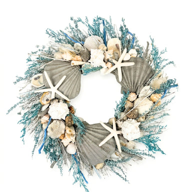 Decorative wreath with seashells, starfish, and greenery on a white background