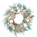 Decorative wreath with seashells, starfish, and greenery on a white background