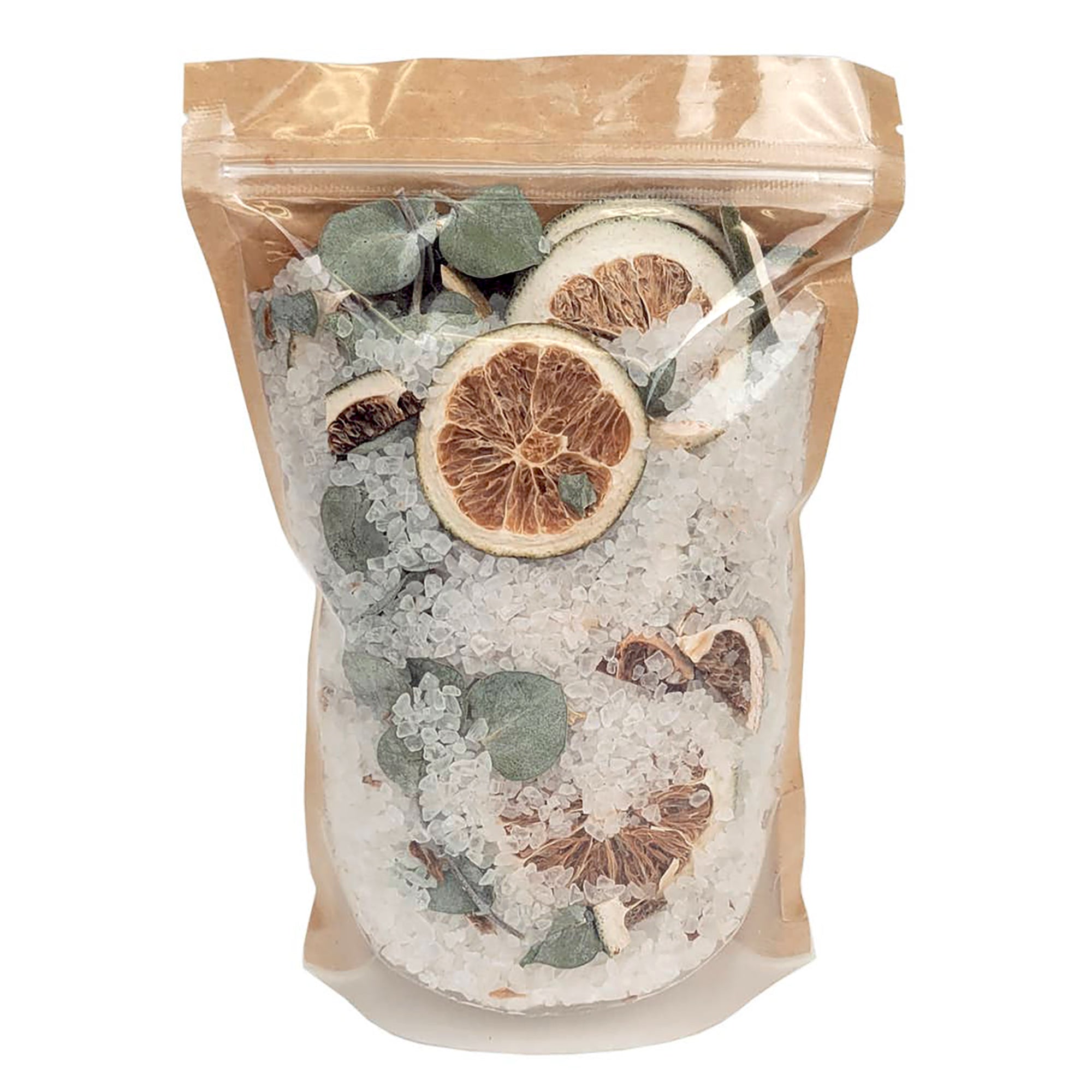 A clear resealable stand-up pouch with a kraft paper top, filled with coarse white crystals and dried botanicals including green leaves and dried citrus slices, photographed on a plain white background.