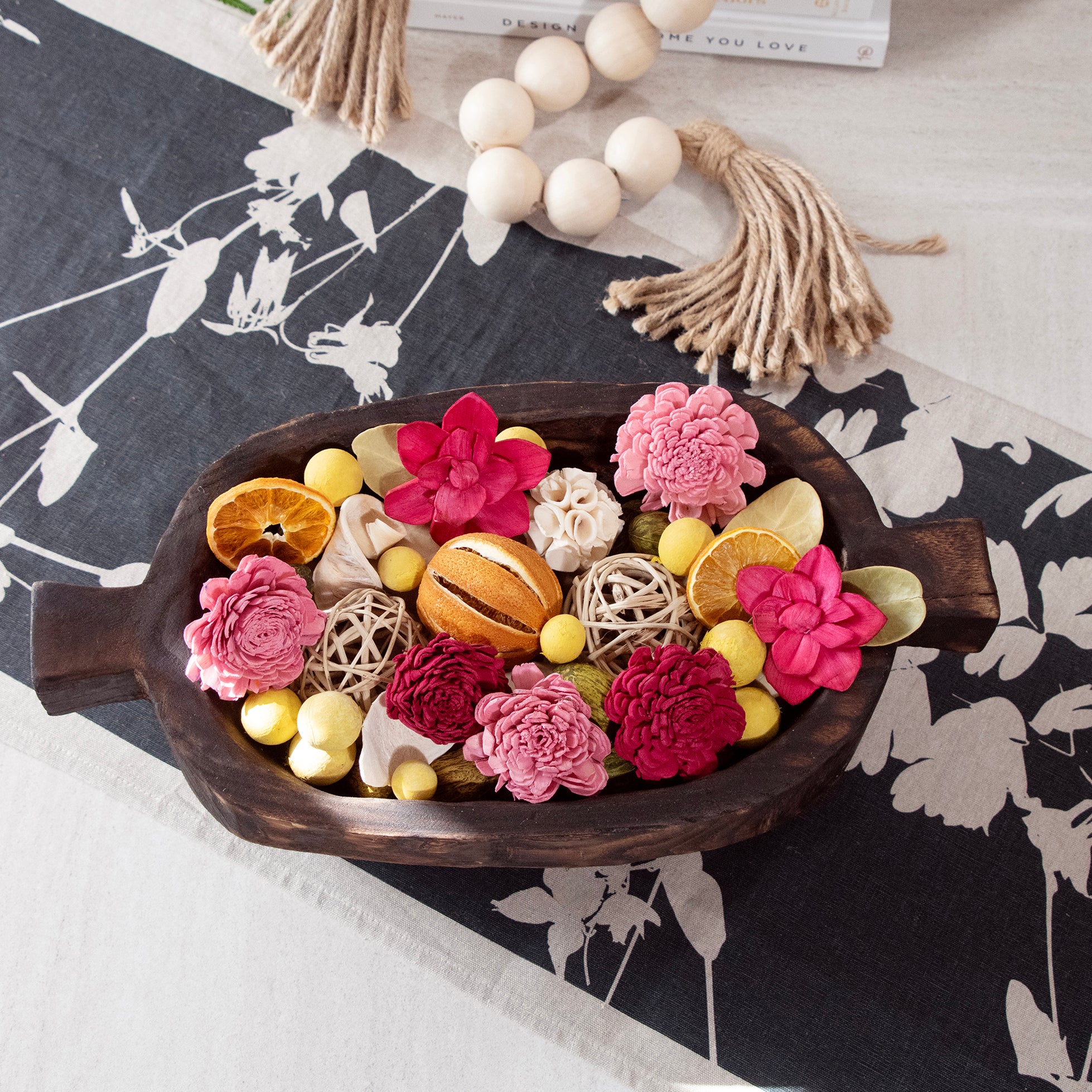 Overhead view of Forbidden Flower Oasis Potpourri, displayed in a wood bowl.