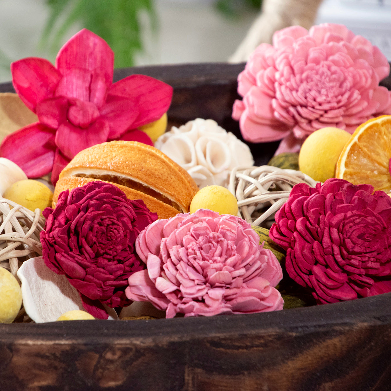 Close up of  Forbidden Flower Oasis Potpourri, displayed in a wood bowl.