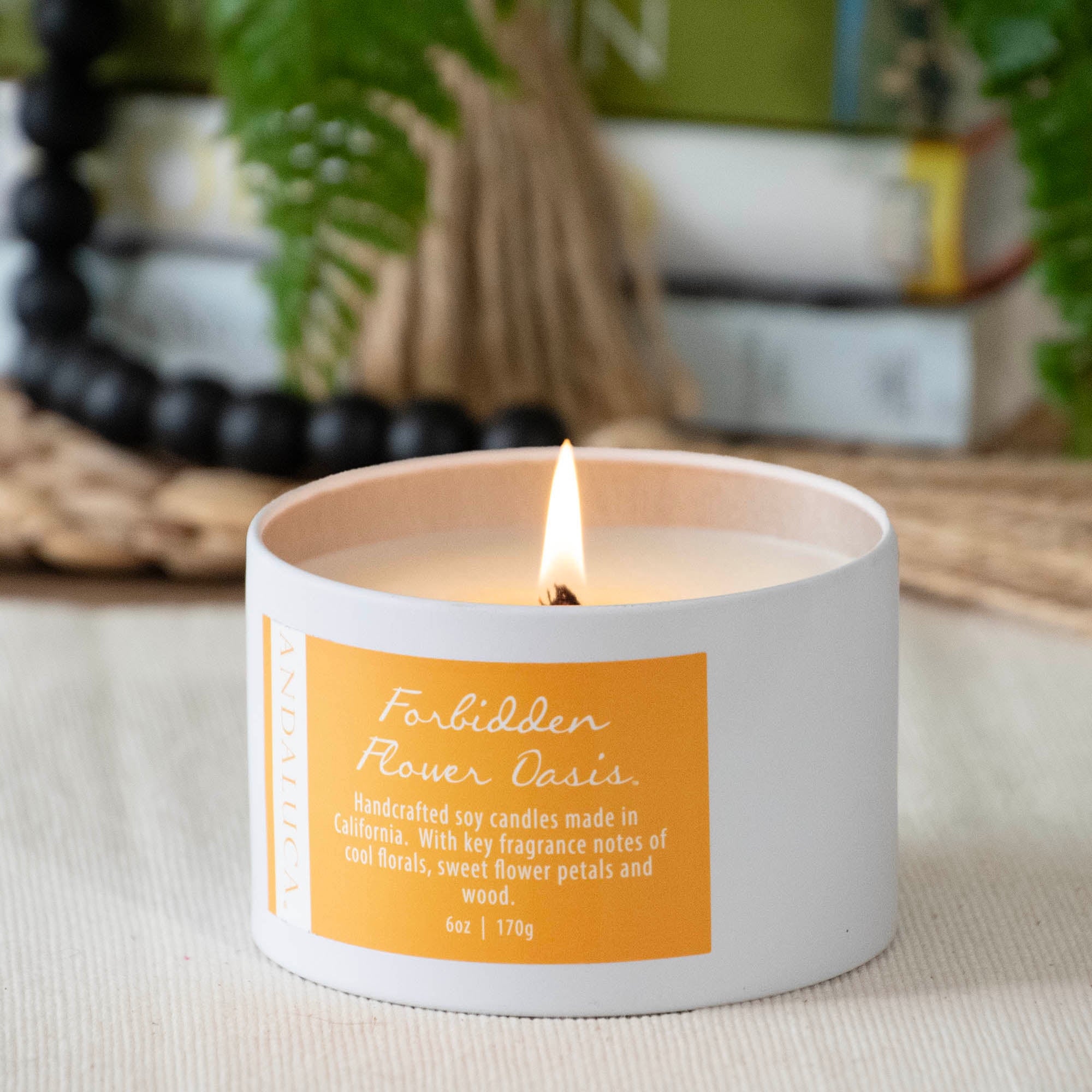Forbidden Flower Oasis Tin Candle, burning.