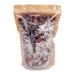A clear resealable stand-up pouch with a kraft paper top, filled with dried lavender sprigs and pink rose petals over white crystalline powder, shown on a plain white background.