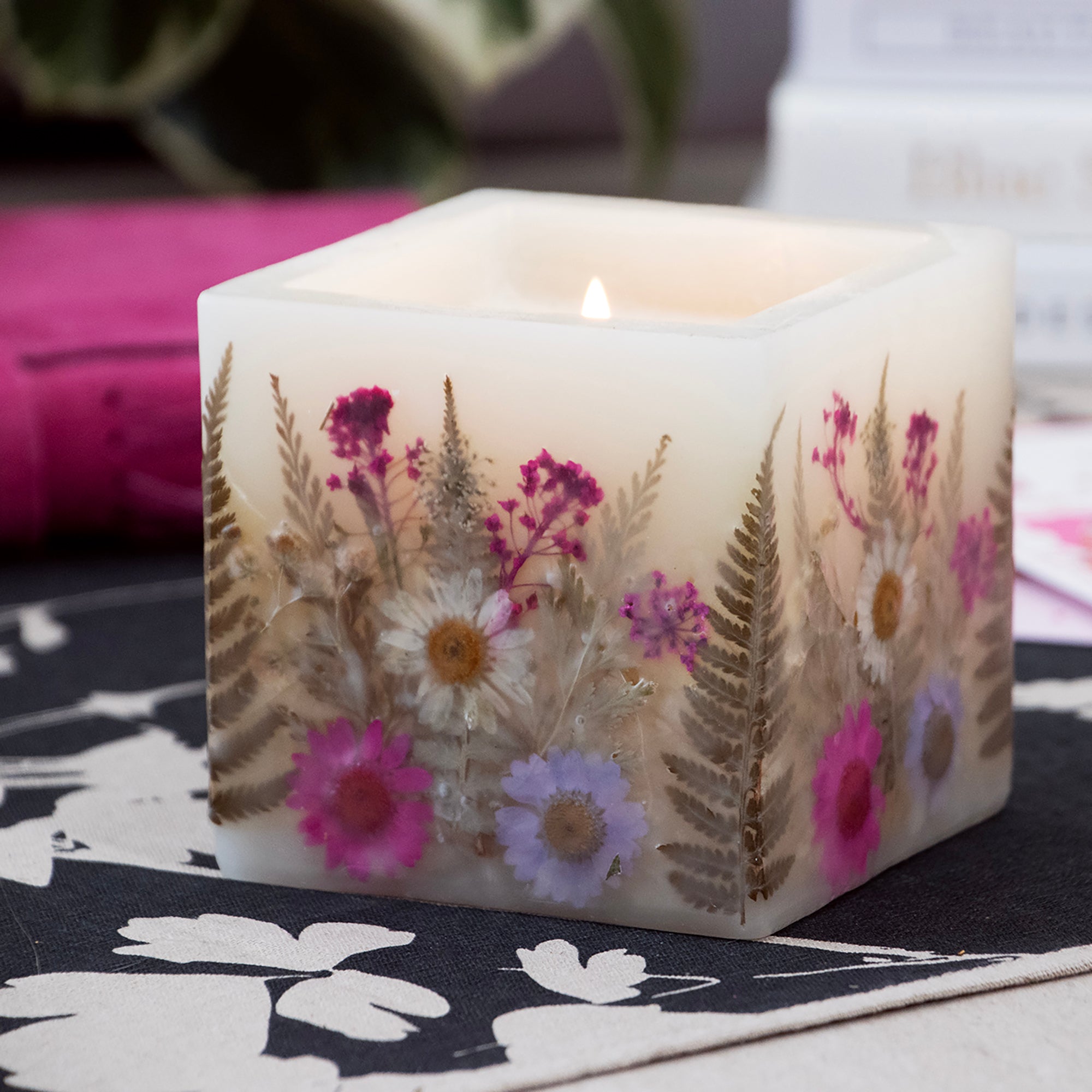 Fresh Peony Pressed Flower Hurricane Candle in a room setting.