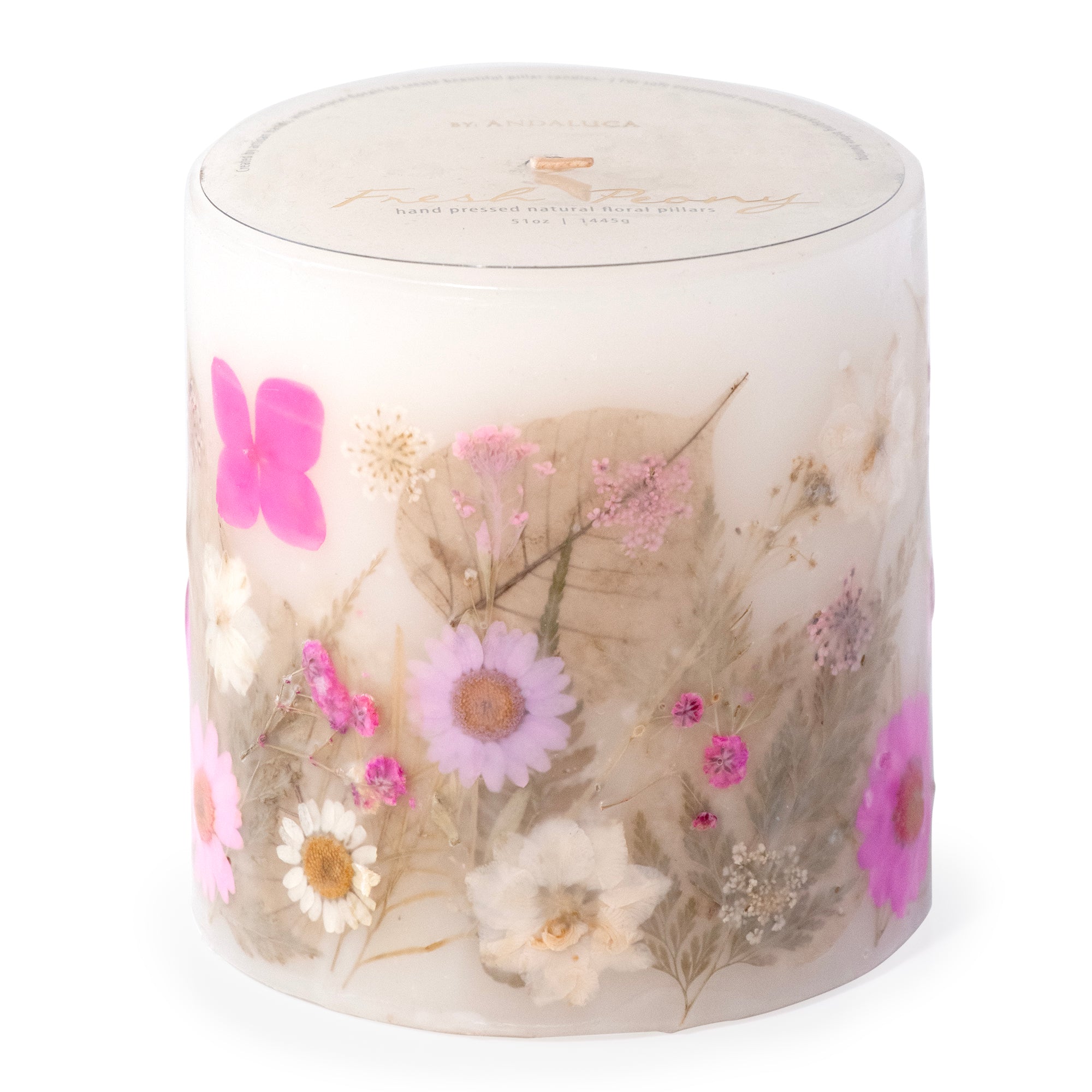 Ivory pillar candle with delicate pink and ivory pressed flowers and green leaves decorating the outside of the candle.