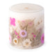 Ivory pillar candle with delicate pink and ivory pressed flowers and green leaves decorating the outside of the candle.