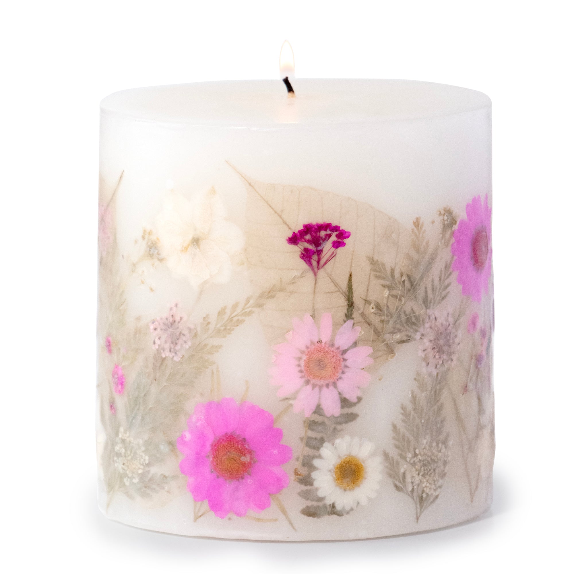 Ivory pillar candle with delicate pink and ivory pressed flowers and green leaves decorating the outside of the candle.