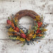 Floral artichoke half wreath.