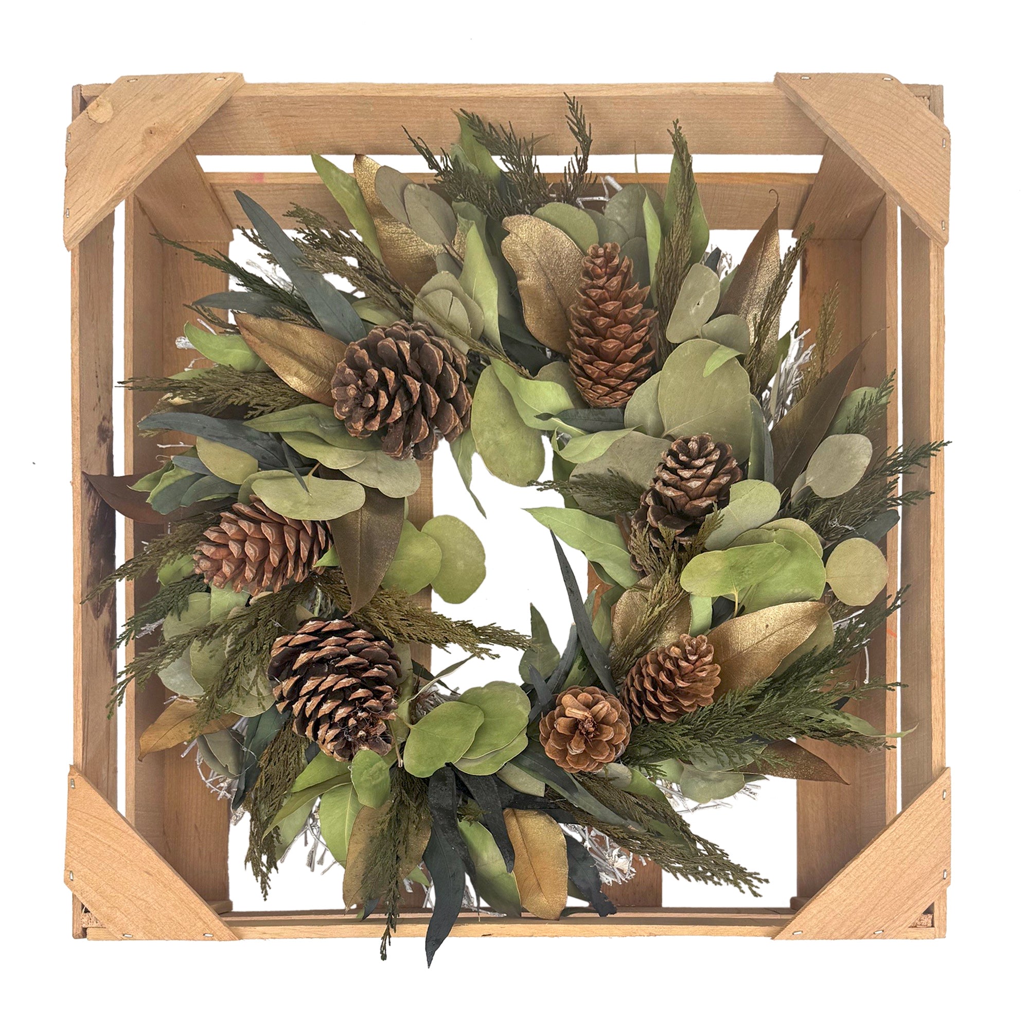 Decorative wreath with pine cones and greenery in a wooden frame on a white background