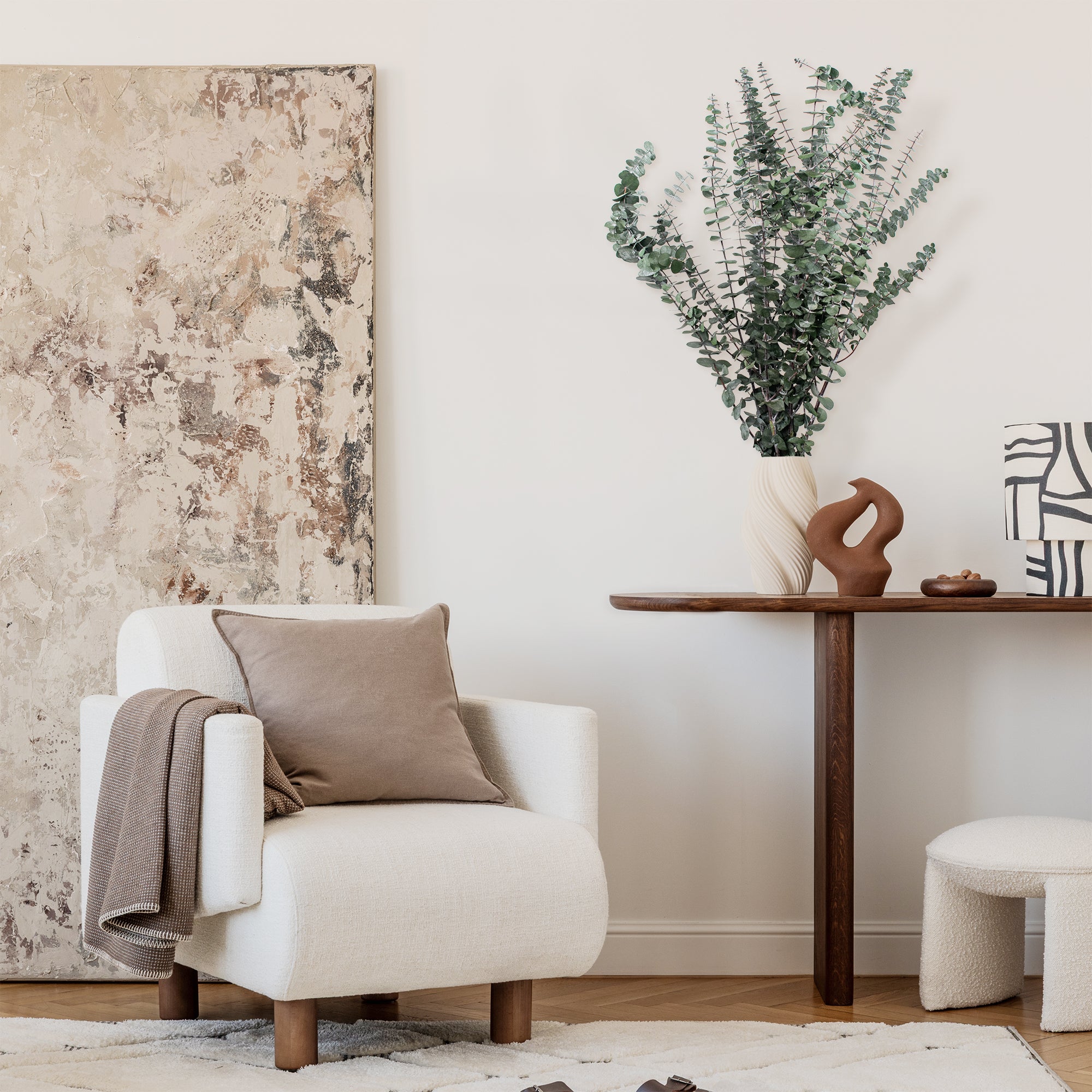 Green Baby Eucalyptus Preserved Bundle in a vase, set on a table.